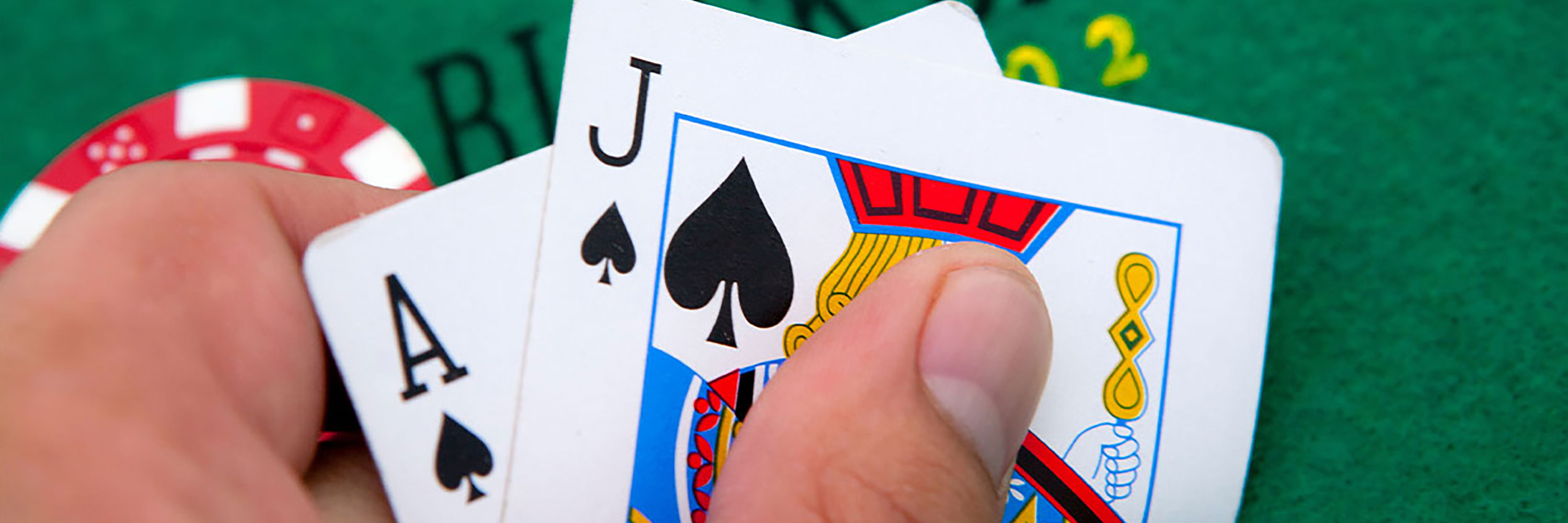 A hand holding an ace and a jack