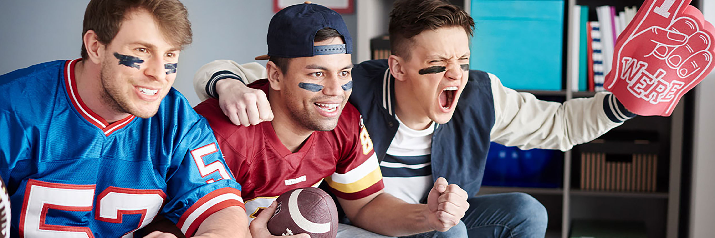 Guys cheering watching the football game