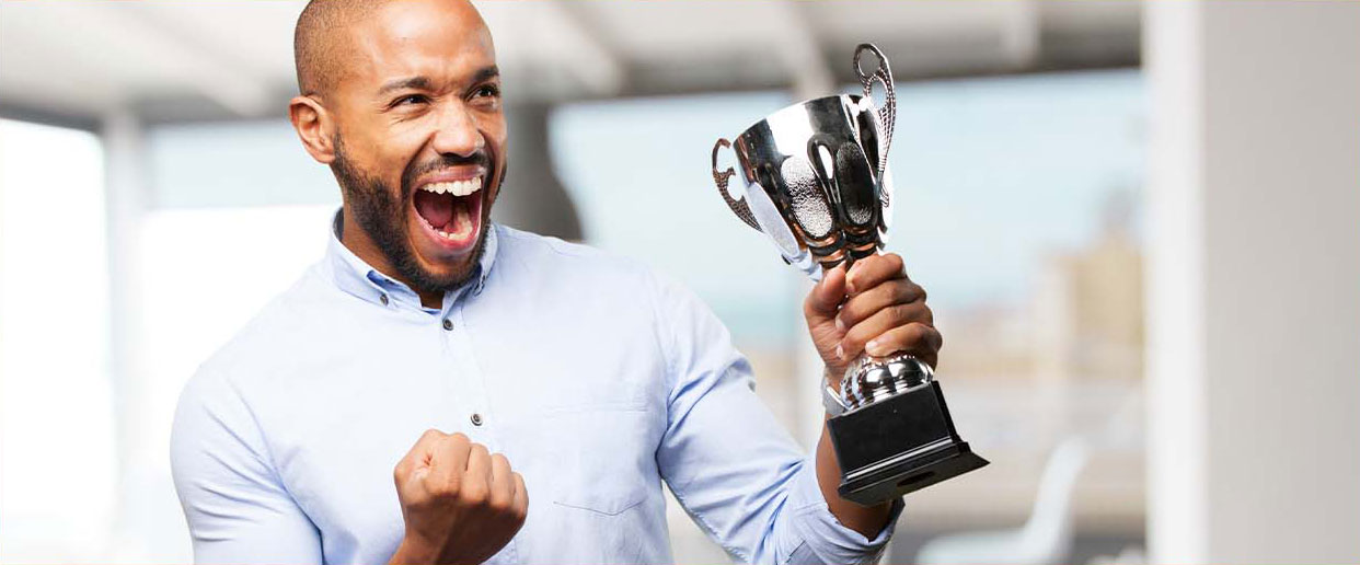 Photo of a man excited with a trophy